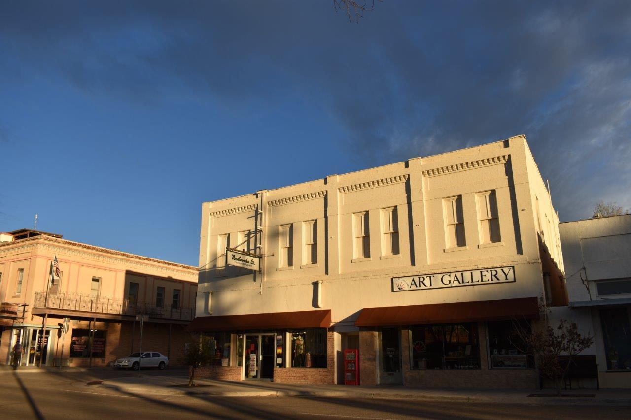 The Holland Hotel and neighboring storefronts in downtown Alpine, Texas, in low morning light