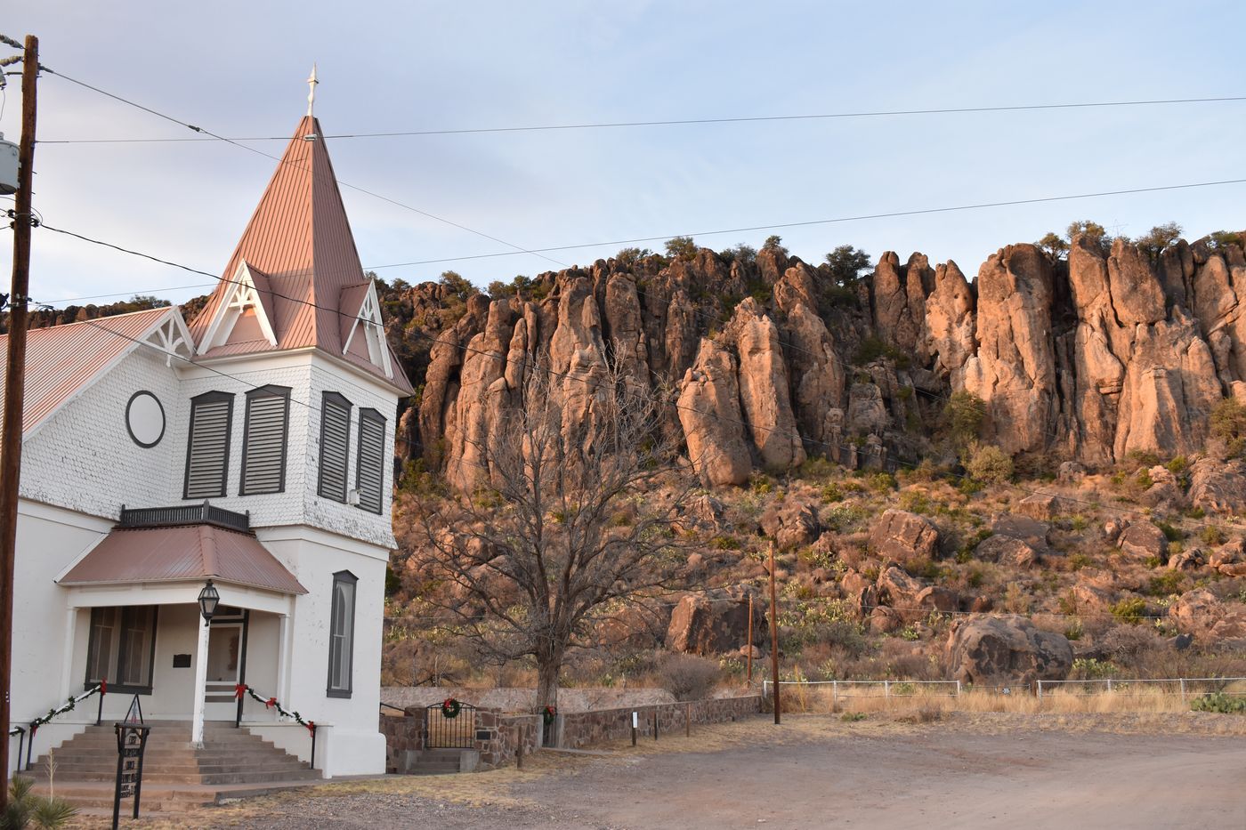 Fort Davis United Methodist Church in Fort Davis, Texas, below the columns of rock on the ridge behind the town