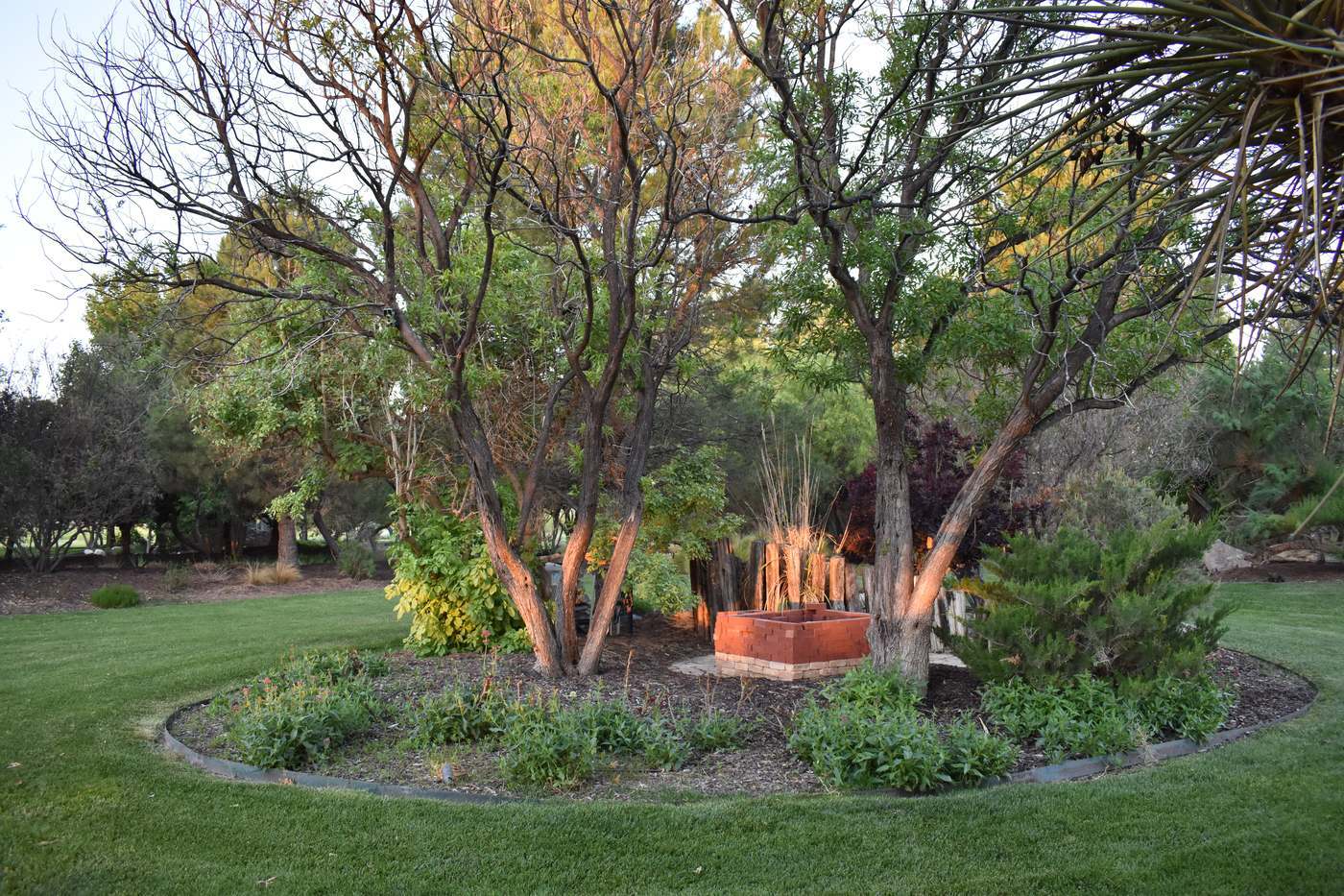 Green lawn, shade trees and planted beds in the Gage Gardens across the tracks from the Gage Hotel in Marathon