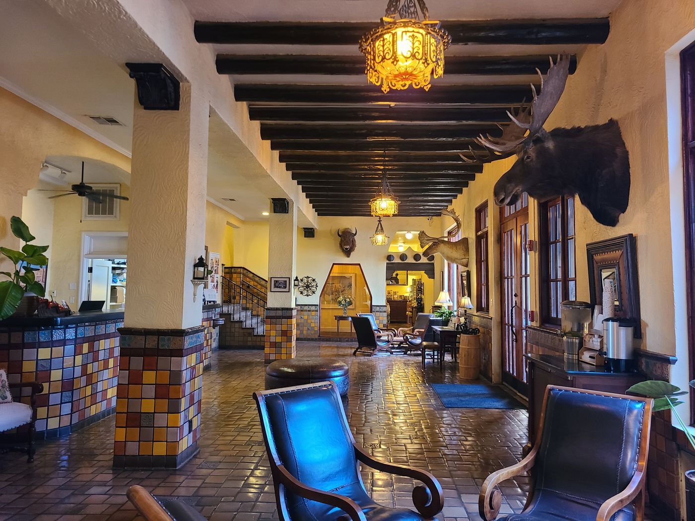 The lobby of the Hotel El Capitan in Van Horn, Texas, with tiled columns, dark beams and leather chairs