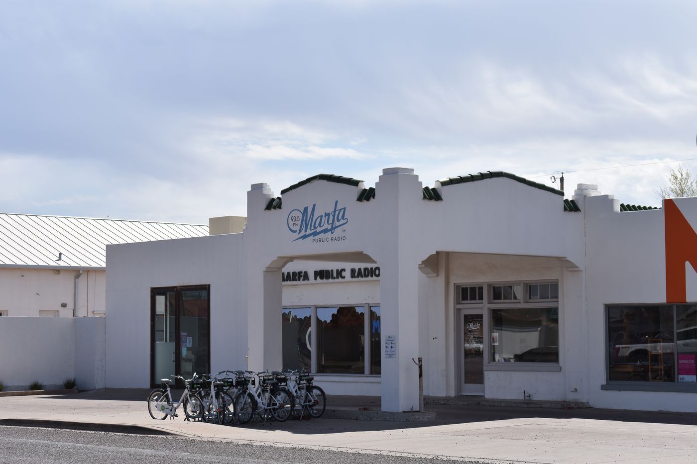 The Marfa Public Radio building with bicycles parked along its front wall