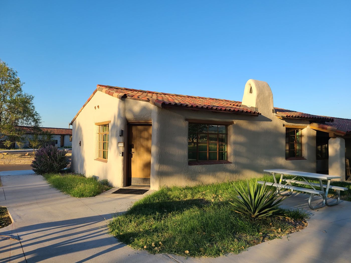 An adobe guest building with a tile roof at San Solomon Courts inside Balmorhea State Park