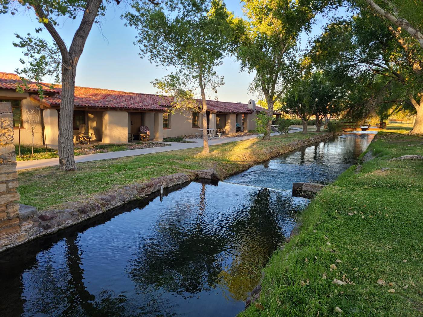 Adobe guest buildings at San Solomon Courts lining the clear spring-fed canal inside Balmorhea State Park